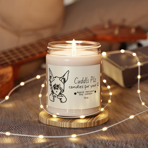 Candle in a jar with a label featuring a crude illustration, surrounded by string lights on a wooden surface.