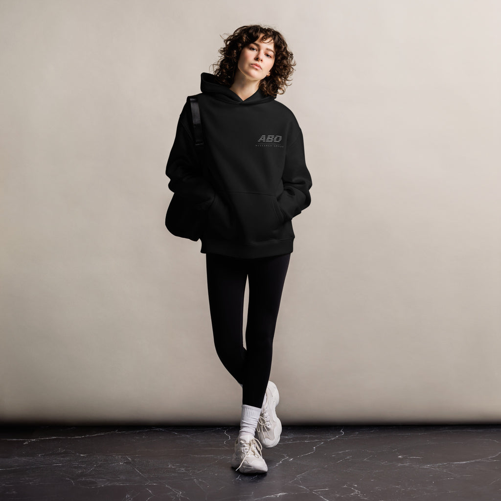 Person wearing a black hoodie with 'ABO' logo against a plain background