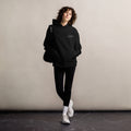 Person wearing a black hoodie with 'ABO' logo against a plain background